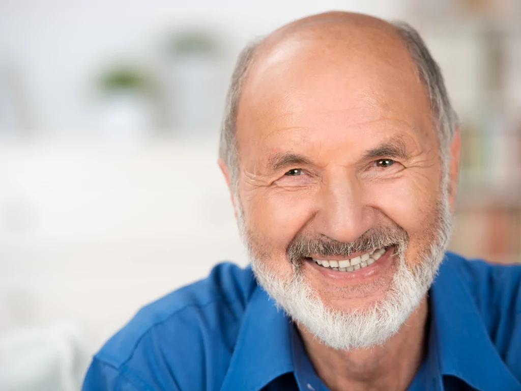 older happy man with beautiful restored smile he got in Logan UT