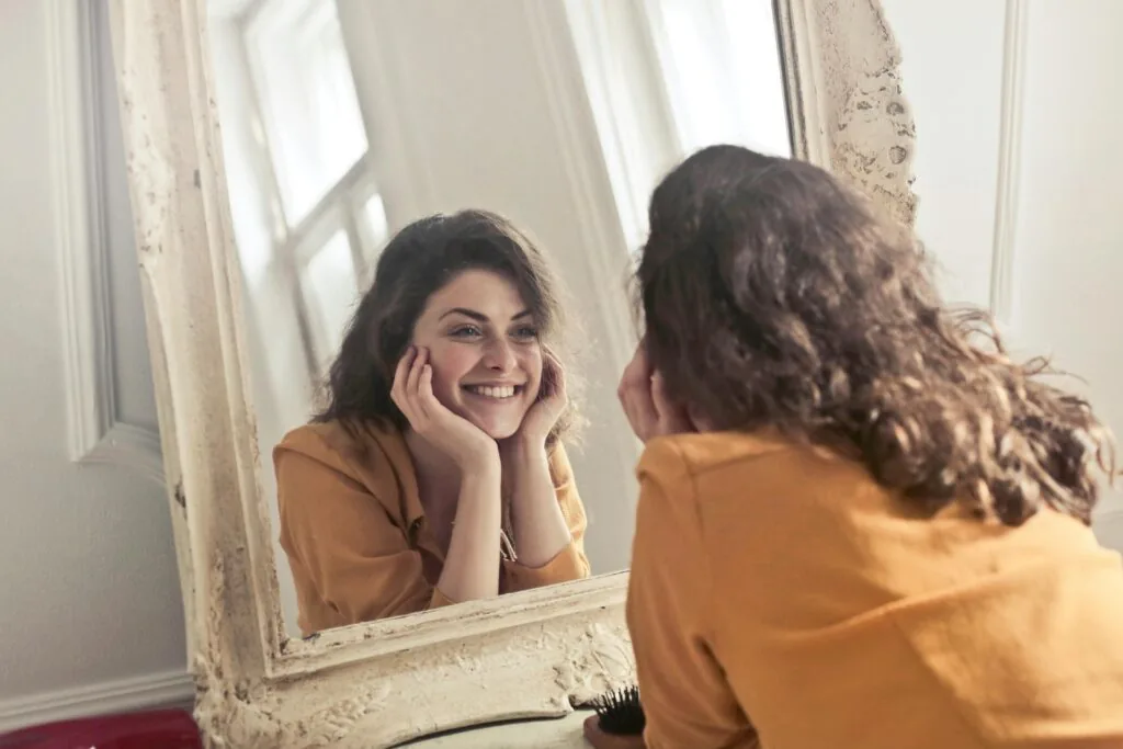 Cache Valley woman admiring her straight teeth after using clear braces