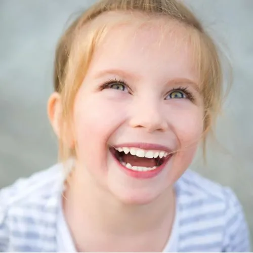 Logan, UT child smiling after seeing family dentist