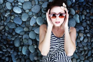 A young woman reclining on rocks after sedation dentistry in Logan.
