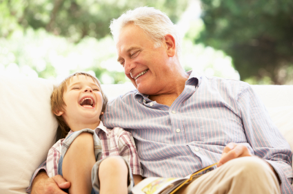 A grandfather and grandchild laughing thanks to restorative dental treatments in Logan.